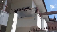 Izin rumah kost Jakarta: rumah dua lantai dengan spanduk terima kos