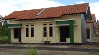 deretan rumah subsidi 2026 satu lantai bercat krem dengan kusen hijau